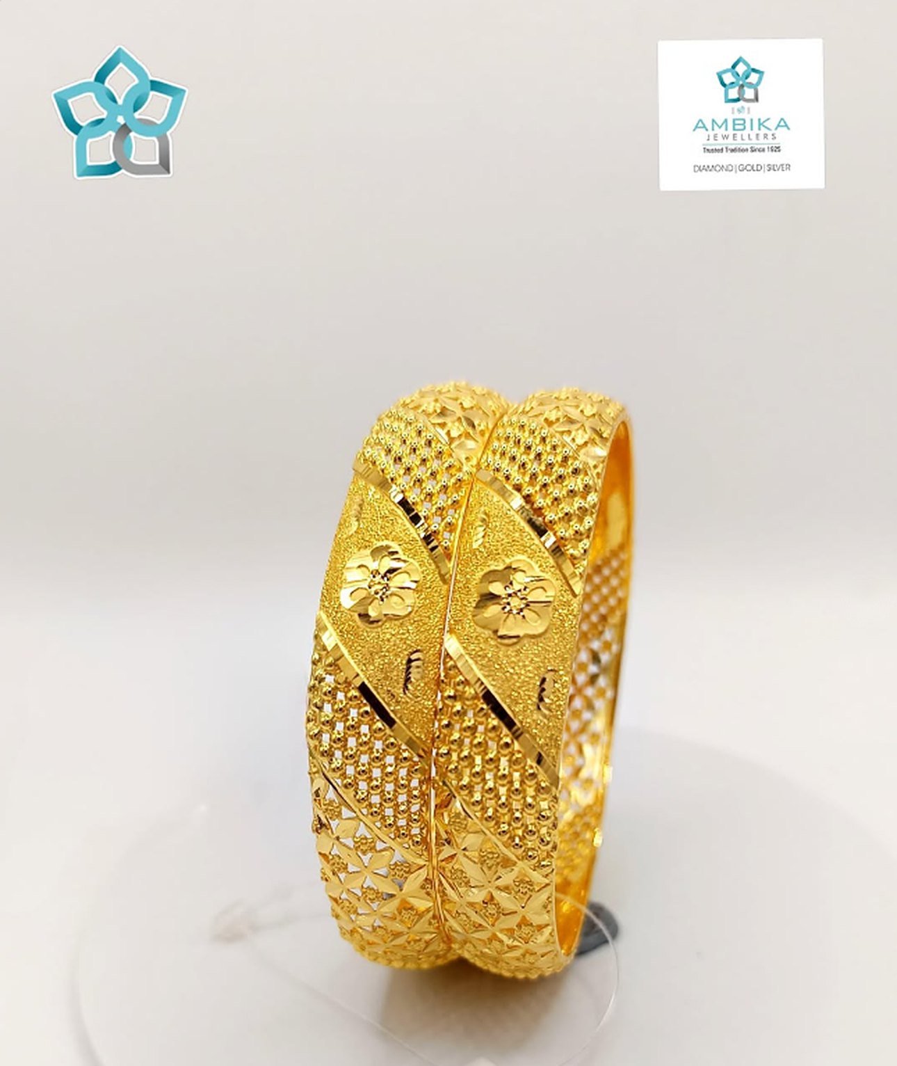 Pair of gold bangles with floral design