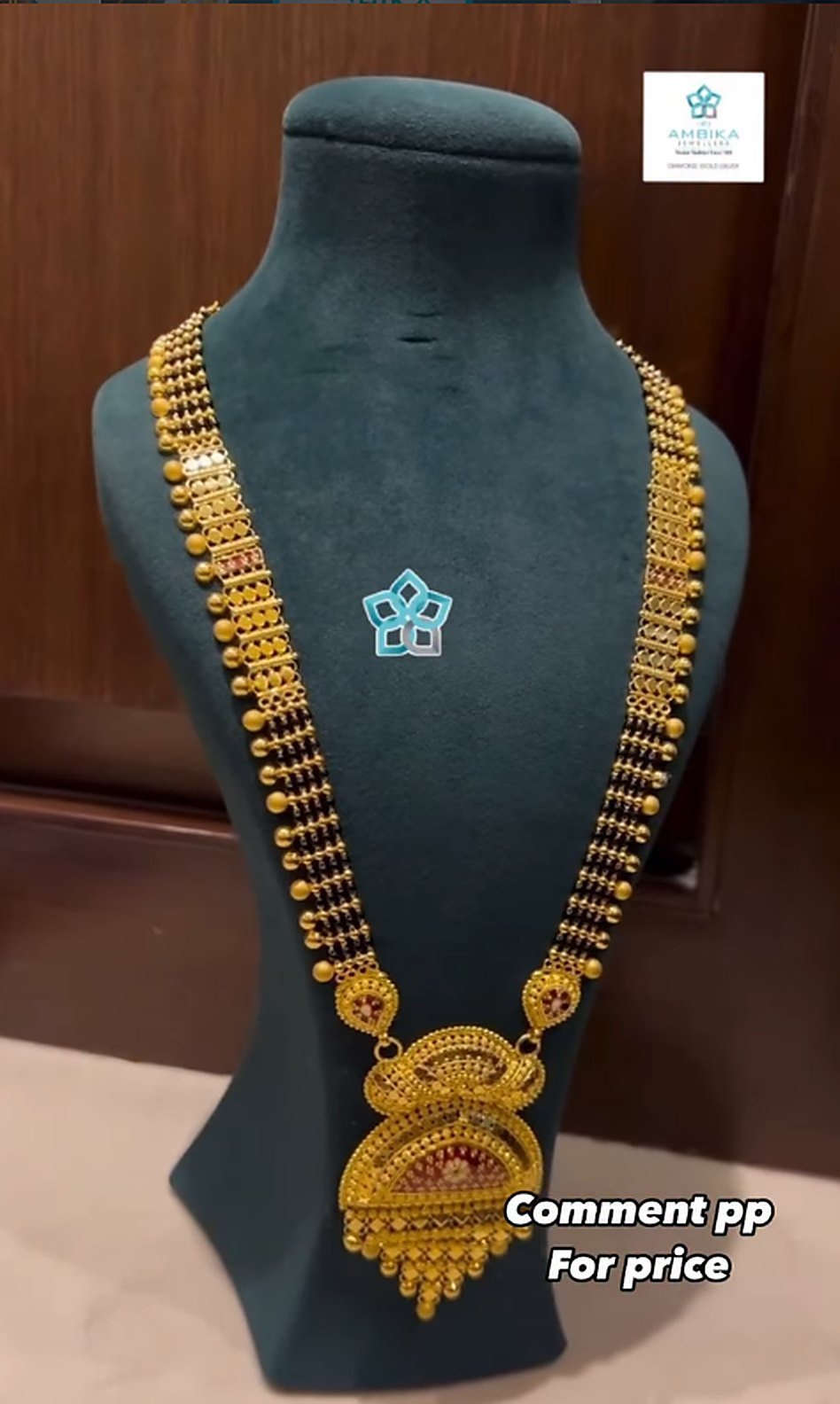Long gold mangalsutra haar with black beads and pendant