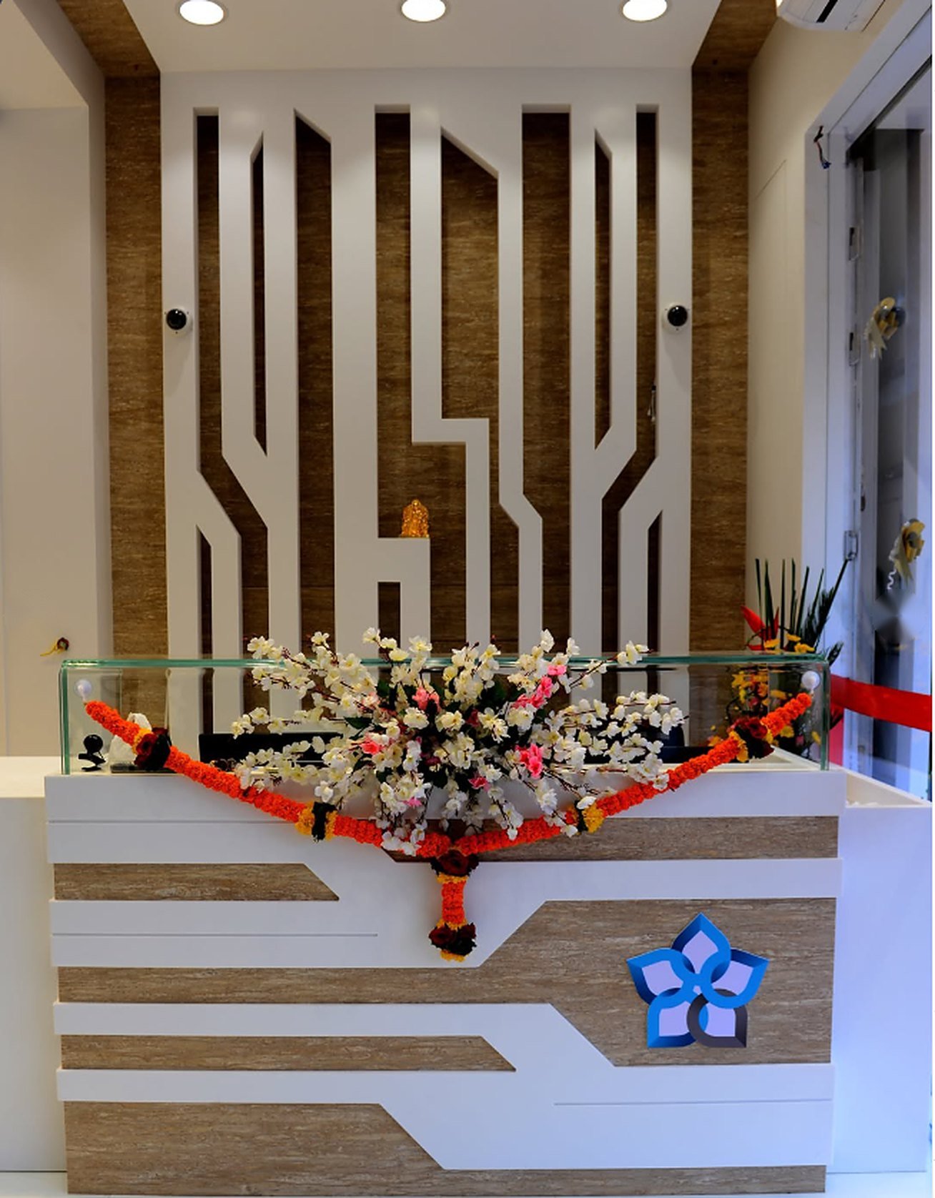 Reception counter decorated with flowers at Ambika Jewellers